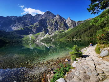 Scenic view of lake and mountains against sky