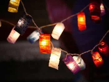 Low angle view of illuminated lanterns hanging at night