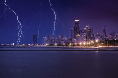 Illuminated city at waterfront