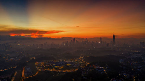 High angle view of buildings against sky during sunset