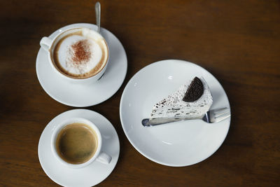 High angle view of cappuccino and coffee on table