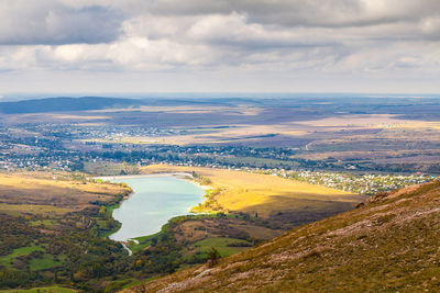 Aerial view of landscape against cloudy sky