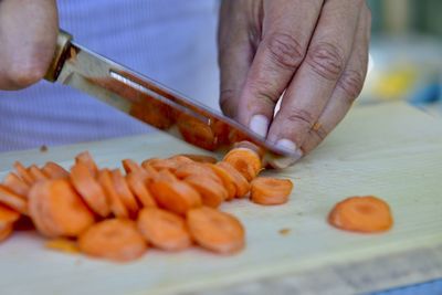 Close-up of man preparing food on cutting board