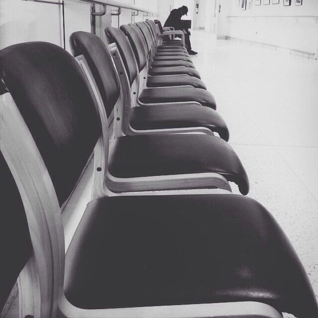 transportation, indoors, in a row, empty, railing, modern, absence, mode of transport, no people, built structure, high angle view, diminishing perspective, architecture, public transportation, seat, the way forward, day, repetition, sunlight, metal