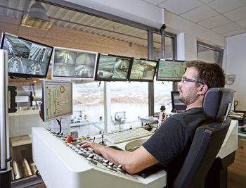 Worker controlling production with monitors