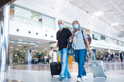 Senior couple with luggage at airport