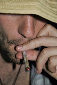 Close-up of man holding cigarette