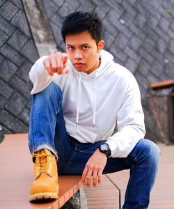 Portrait of young man sitting on seat