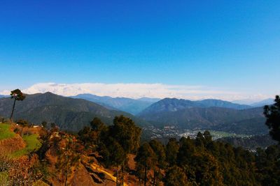 Scenic view of mountains against clear blue sky