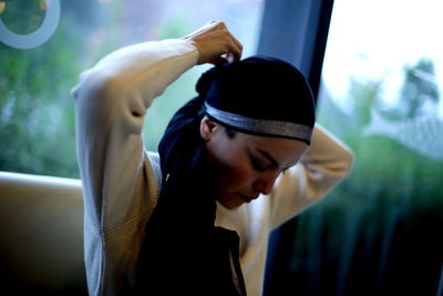 Portrait of young woman wearing hat