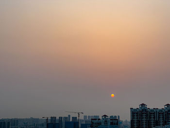 Buildings against sky during sunset