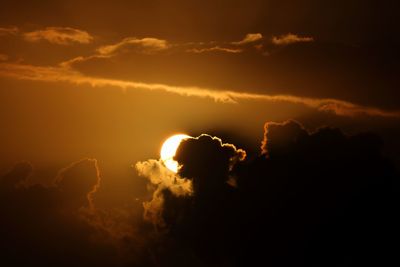 Low angle view of silhouette sun against sky during sunset