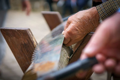 Close-up of hand holding wood