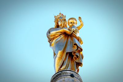 Low angle view of statue against blue sky