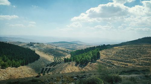 Scenic view of landscape against cloudy sky