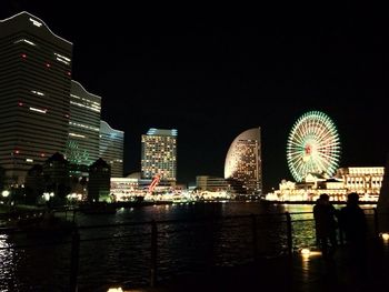 Illuminated ferris wheel at night