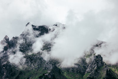 Scenic view of snow covered mountains against sky