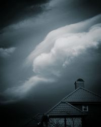 Low angle view of built structure against cloudy sky