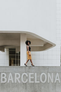 Side view of woman with text against wall