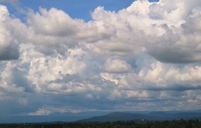 Scenic view of clouds over landscape against sky