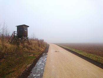 Road by landscape against sky