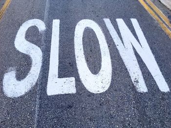 High angle view of slow text on road