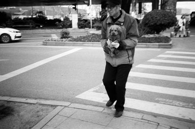 Full length of man crossing road