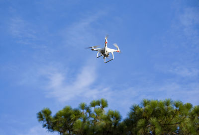 Low angle view of airplane flying in sky