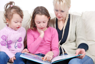 Two women sitting on book