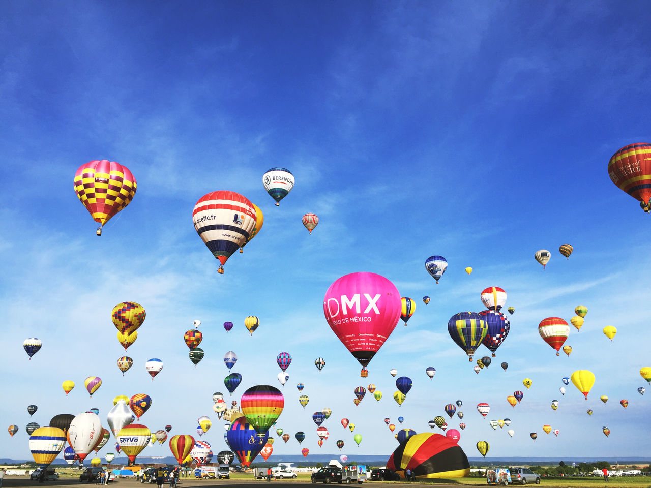 sky, multi colored, mid-air, flying, blue, hot air balloon, balloon, fun, parachute, leisure activity, transportation, cloud - sky, low angle view, vacations, colorful, celebration, enjoyment, incidental people, large group of people, outdoors