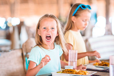 Happy girl sitting in restaurant