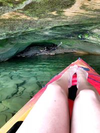 Low section of woman relaxing in swimming pool
