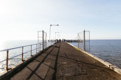 Pier over sea against clear sky