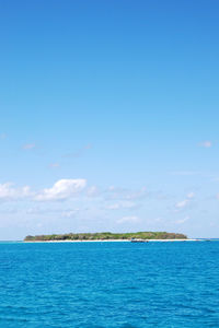 Scenic view of sea against blue sky