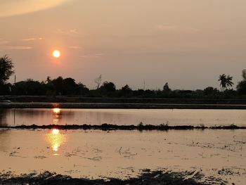 Scenic view of lake against sky during sunset