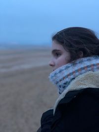 Portrait of woman on beach during winter