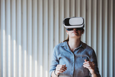 Woman with vr goggles enjoying virtual reality experience