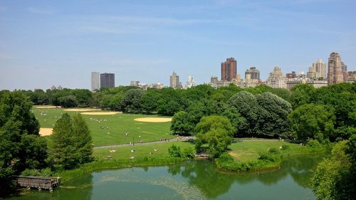 Scenic view of lake by buildings against sky