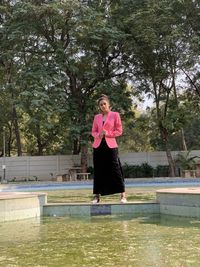 Portrait of woman standing in swimming pool