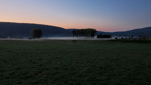 Scenic view of field against sky during sunset