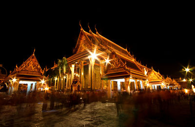 Illuminated temple against sky at night