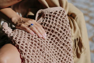 Close-up of woman hands holding woven eco tote bag 