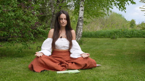 Woman meditating at public park