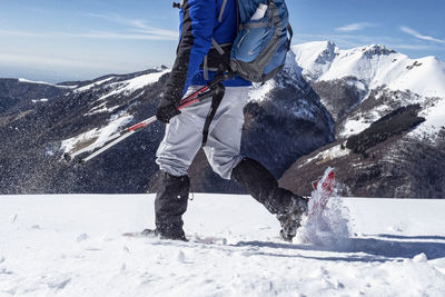 Snowshoeing scene in the italian alps