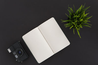 High angle view of camera on table against black background