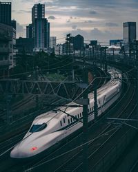 High angle view of railroad tracks in city against sky