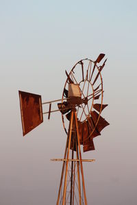 Low angle view of traditional windmill against clear sky