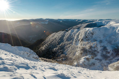 Scenic view of snow covered mountains against sky