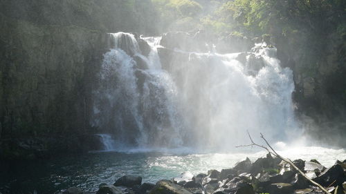 Scenic view of waterfall against sky