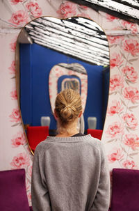 Woman standing in front of mirror